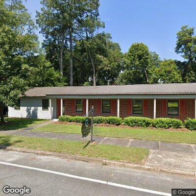 Thumbnail image of the front of a dentist office practice with the name M & C Dental Center which is located in Cochran, GA