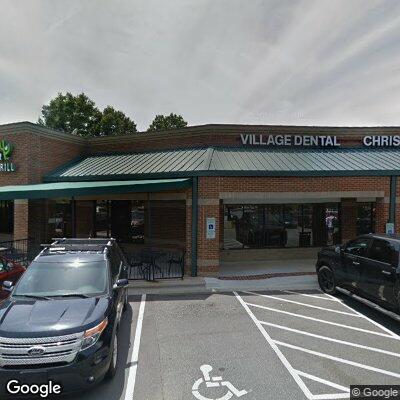 Thumbnail image of the front of a dentist office practice with the name Village Dental which is located in Raleigh, NC